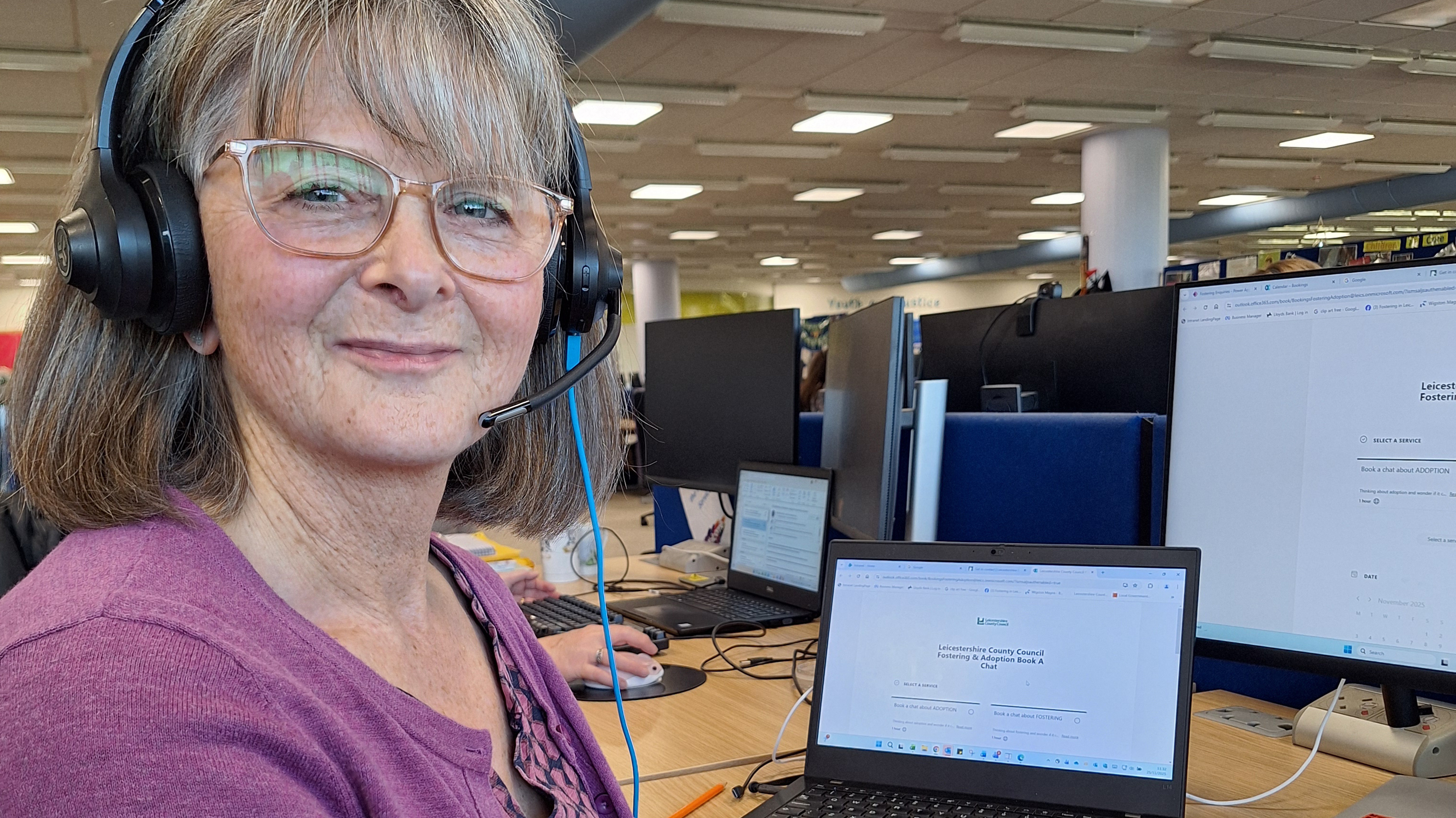 person sitting at desk with headphones on