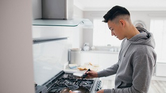 A young person in the kitchen