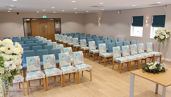 Room set up for a ceremony with the chairs arranged in a theatre style Room set up for a ceremony with the chairs arranged in a theatre style
