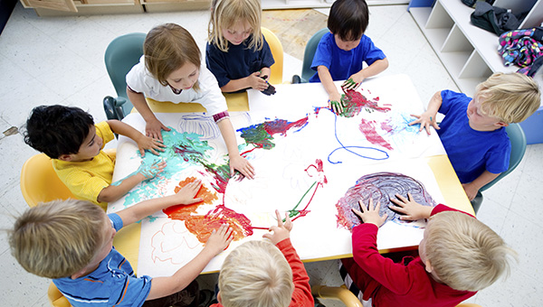 aerial view of children painting whilst sat around a table