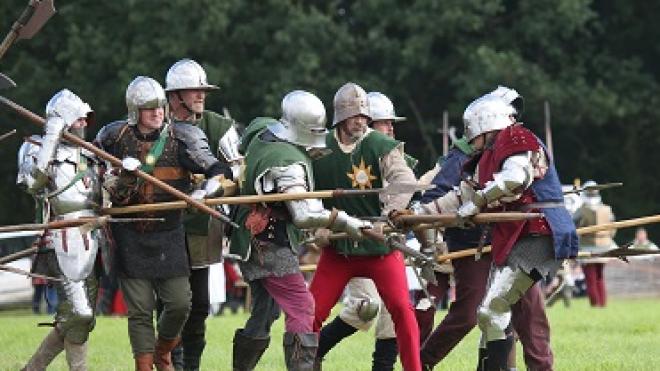 A group of people re-acting a battle at the Bosworth Medieval festival
