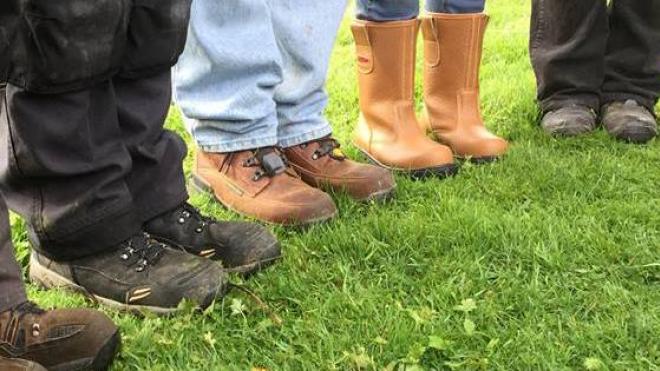 Muddy boots of conservation volunteers