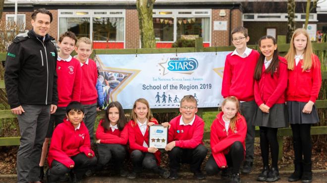 Councillor Blake Pain, county council cabinet member for environment and transport, with pupils from Elizabeth Woodville Primary, Groby Two primary schools in Leicestershire honoured for their commitment to sustainable travel