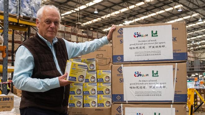 Leader Nick Rushton with the donated face masks man stands next to boxes of boxed up surgical face masks