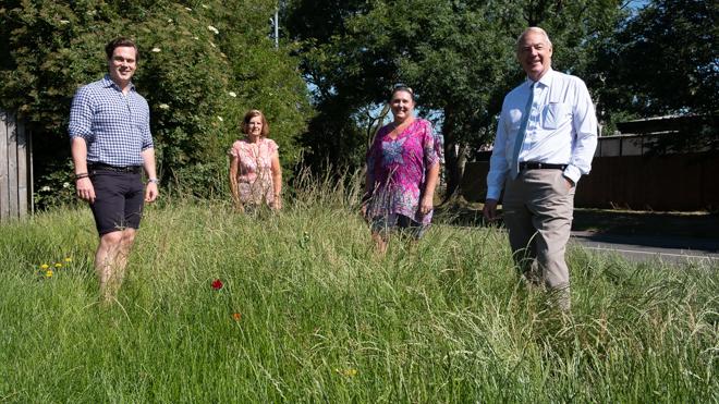 (L-R) Cllr Blake Pain, Parish Councillors Janet Earwaker and Tina Mcdonagh, and Cllr Trevor Pendleton at Fleckney's wild flower verge group of people stood on a grass verge overgrown with wild flowers and plants