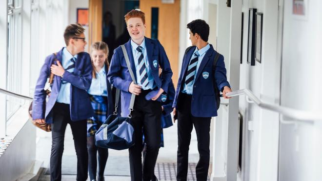 school children walk through school corridor