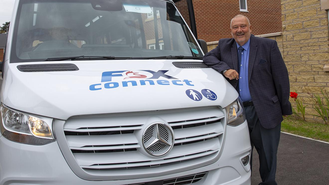 Cllr Ozzy O'Shea with a Fox Connect bus