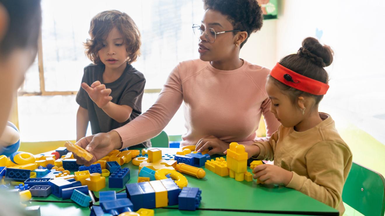 Teacher supporting children in play exercise