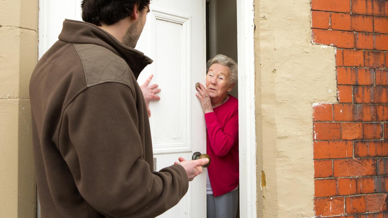 Man at door talking to old woman