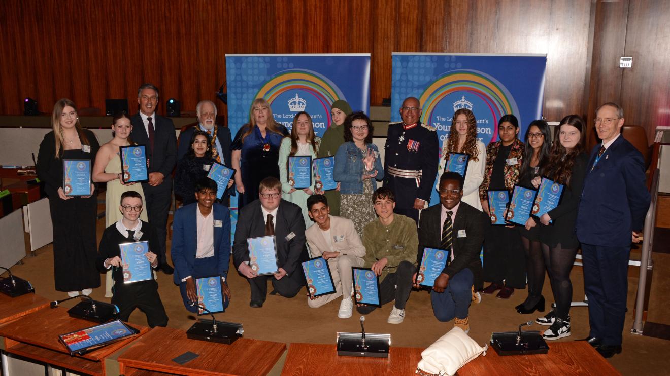 A group of teenagers with their Lord-Lieutenant Young Person of the year certificates 