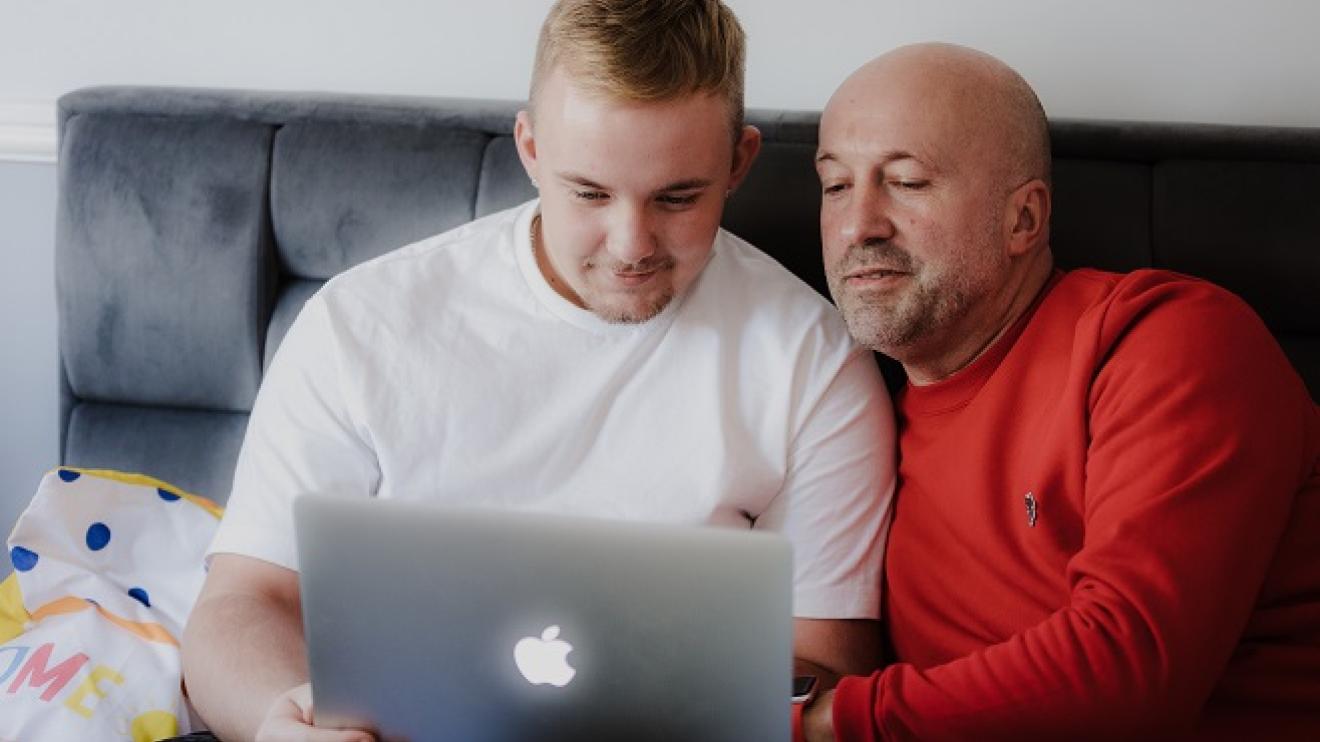 Foster carer and young adult looking at a laptop