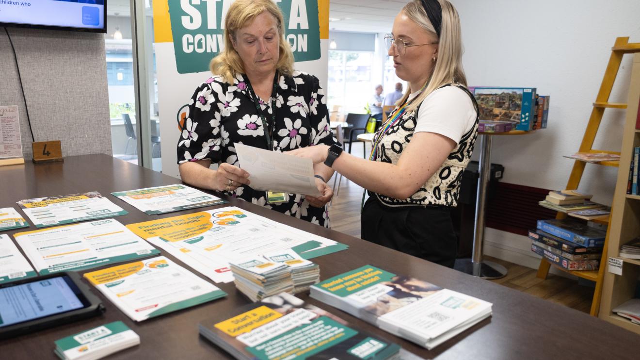 Mental Health Friendly Places Two people reading leaflets