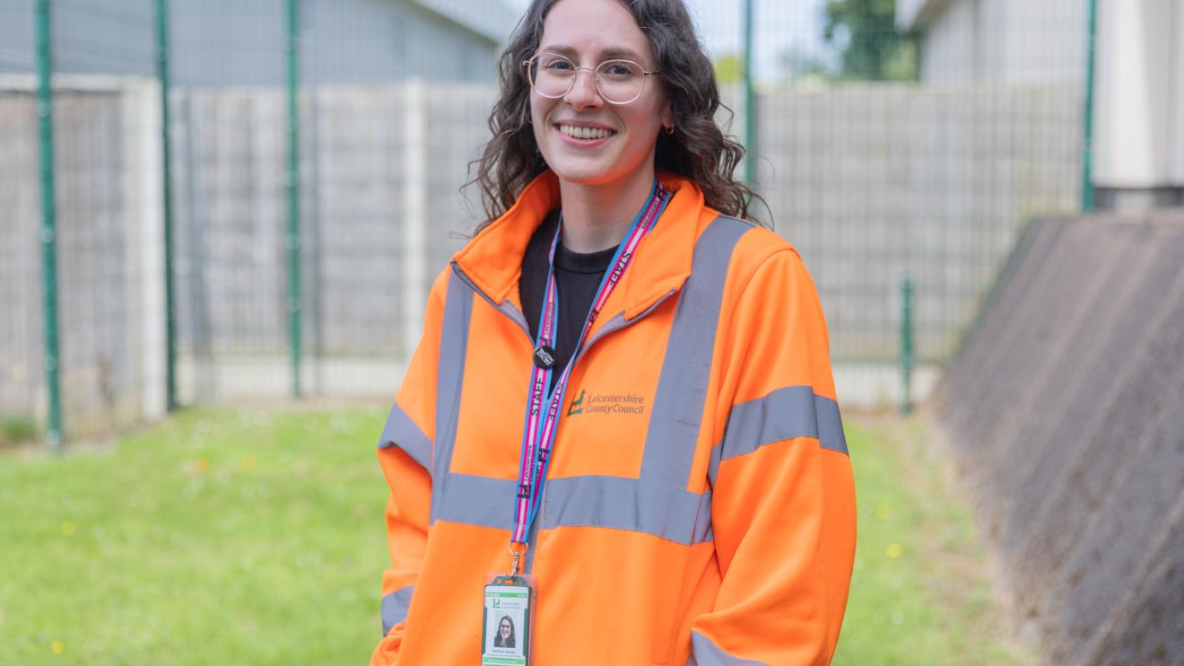 Kathryn smiles in an orange high vis jacket