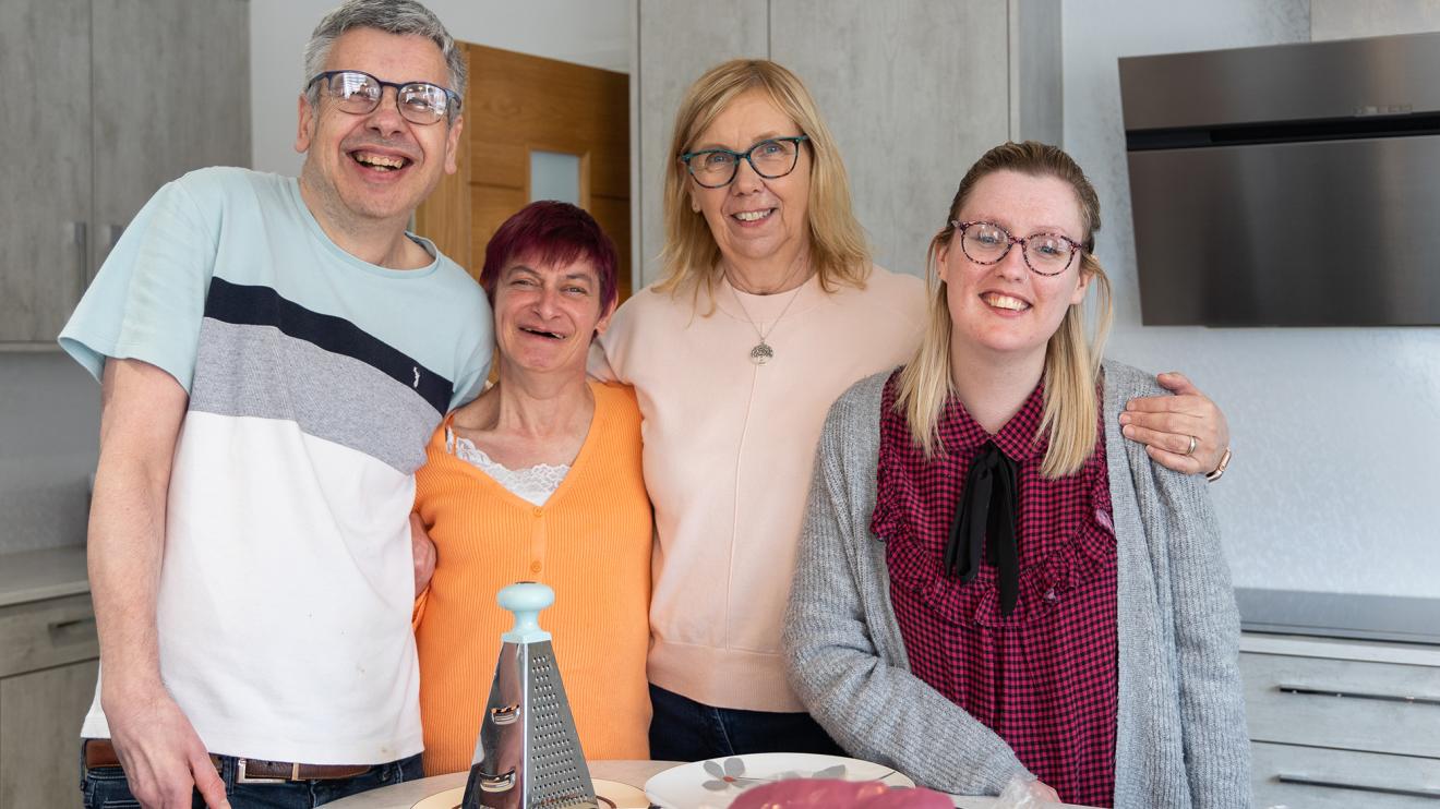 Four people smiling