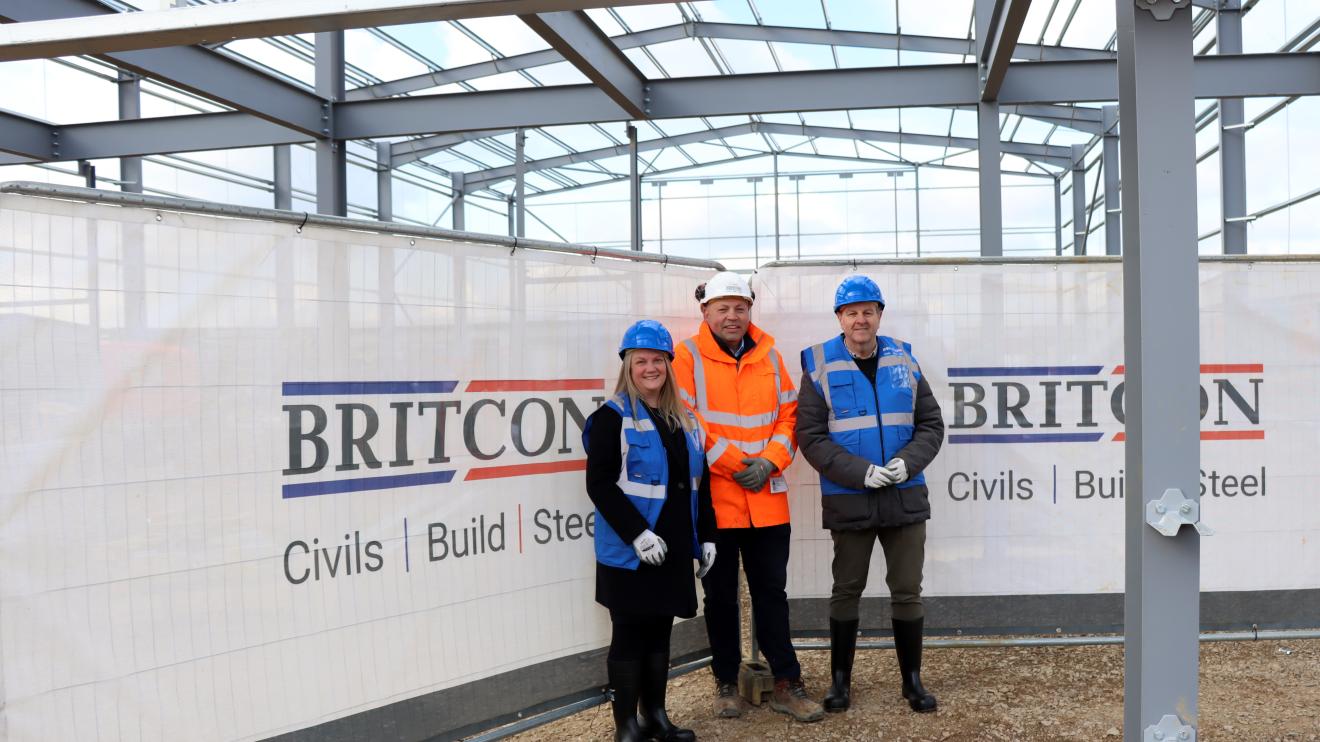 Cllr Lee Breckon with Lucy Littlefair and Lee Noble of Britcon inside the steel structure of Airfield Business Park