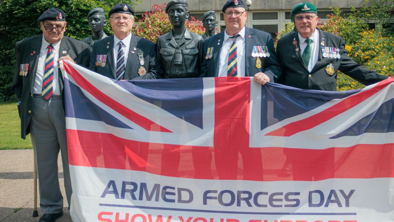 Veterans fly the Armed Forces Day flag
