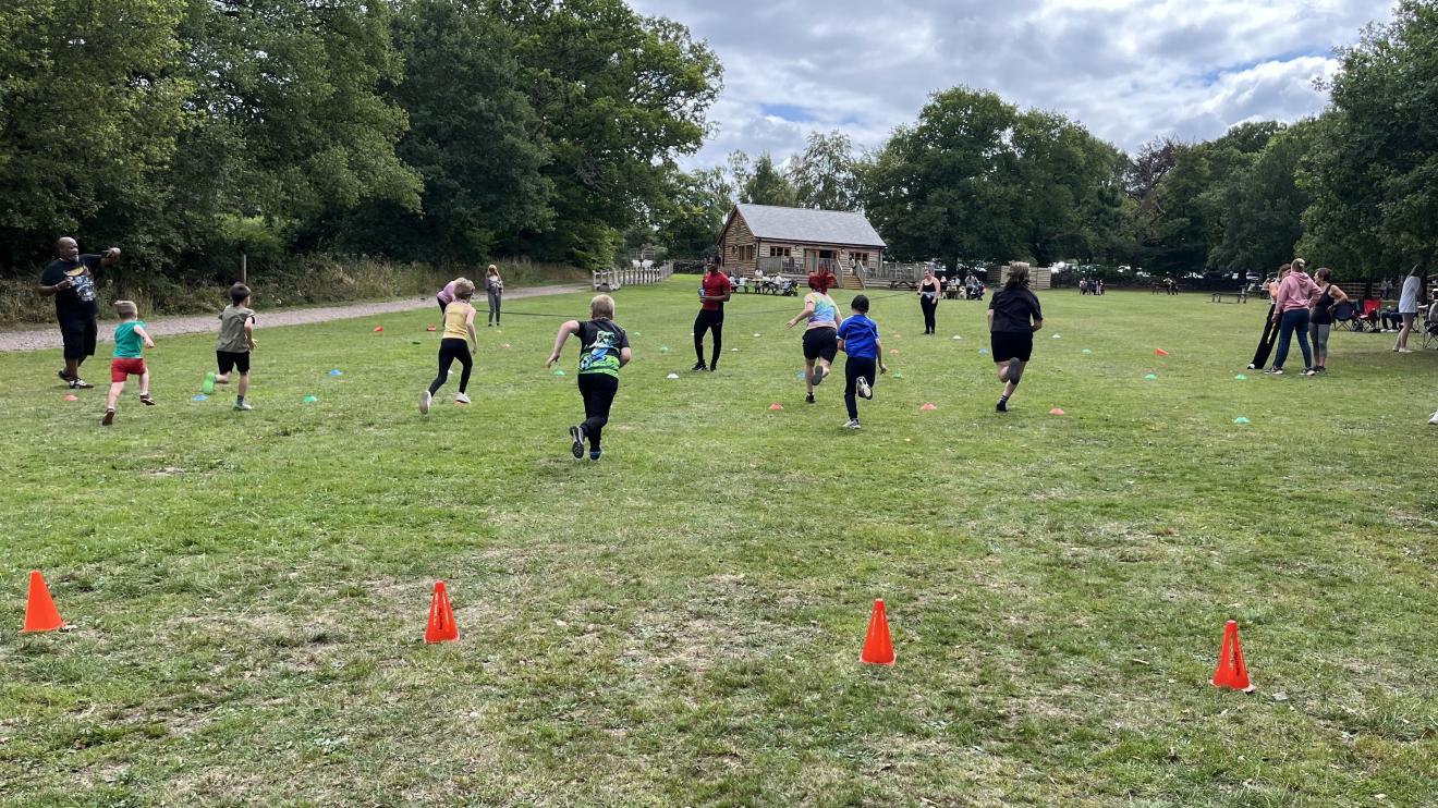Fostival 2025 - relay races A line of children are pictured running away from the camera as they compete in a race