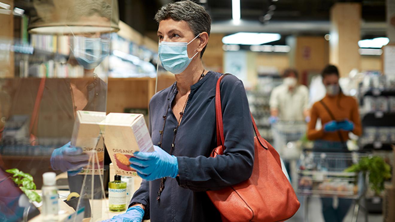 Woman wearing facemask in a shop