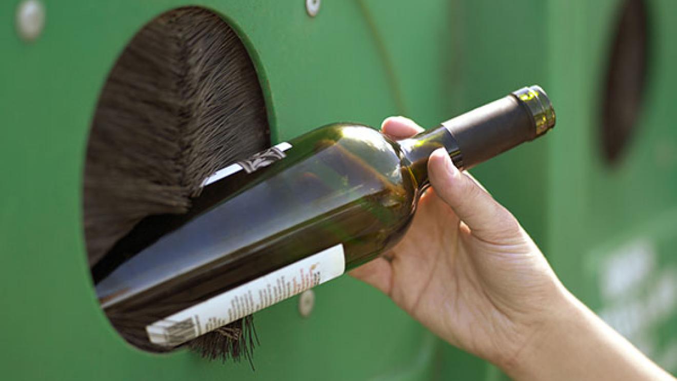 A glass bottle being recycled