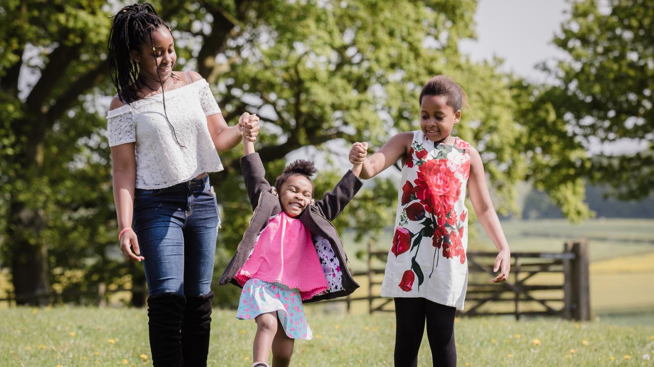 A woman playing outside with children