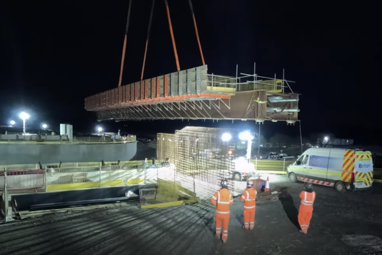rail bridge being lifted into place 