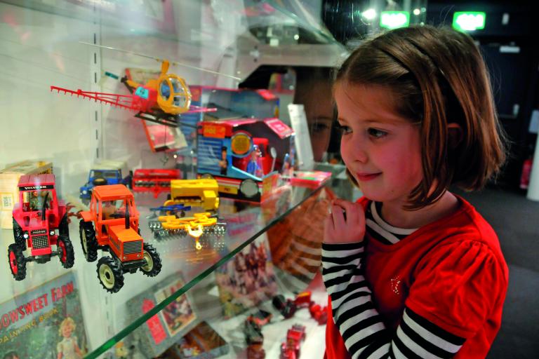Child looks at museum exhibit