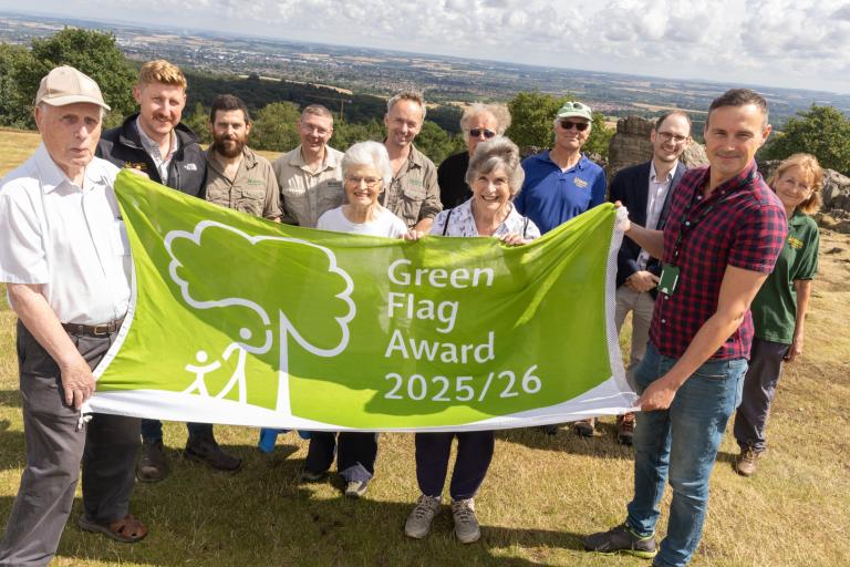 Rangers, volunteers and Cllr Adam Tilbury with Green Flag award at Beacon Hill Country Park