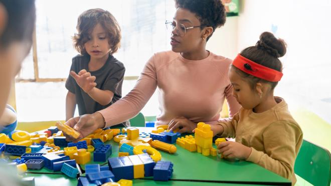 Teacher supporting children in play exercise