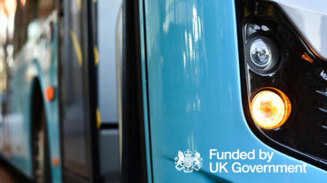 Close up of a bus accompanied by the 'funded by UK government' logo