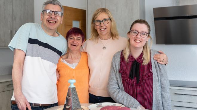 Four people smiling