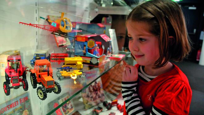 Child looks at museum exhibit