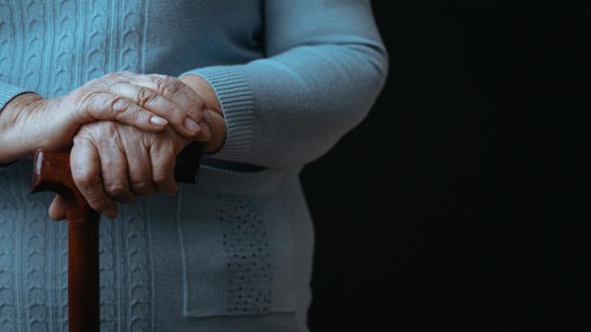 An old person holding a walking stick