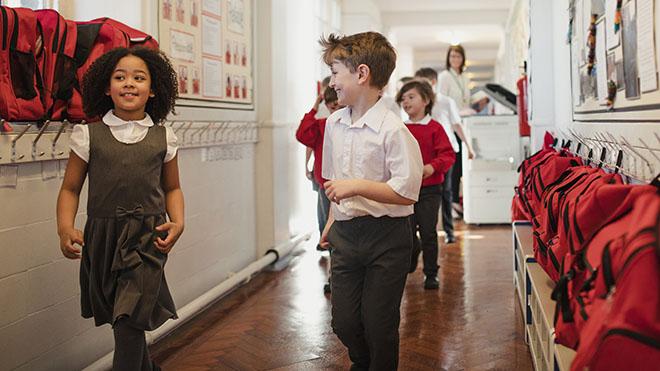 Schoolchildren in classroom corridor