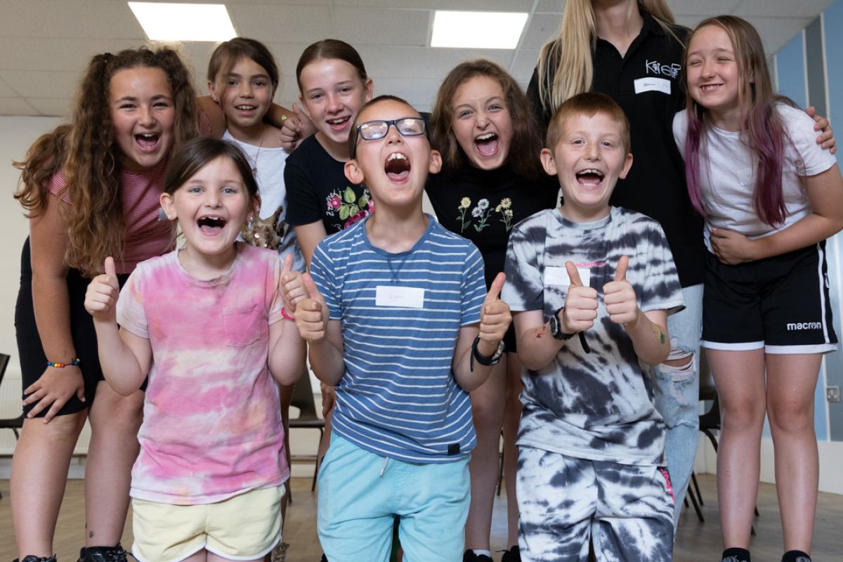 Group of children and staff members smiling