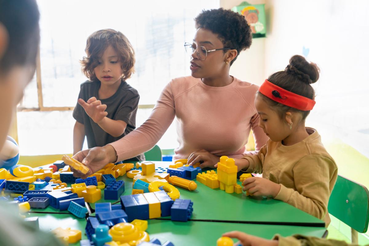 Teacher supporting children in play exercise