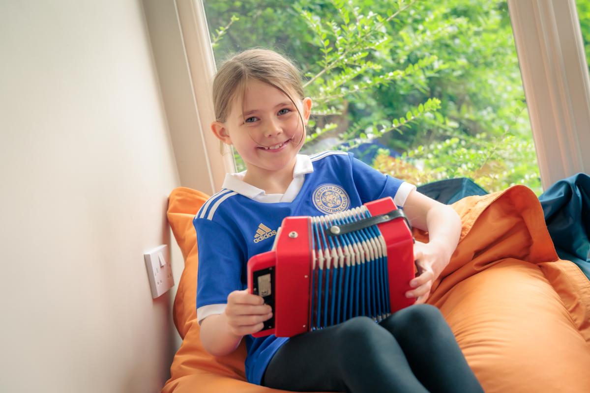 child playing with musical toy