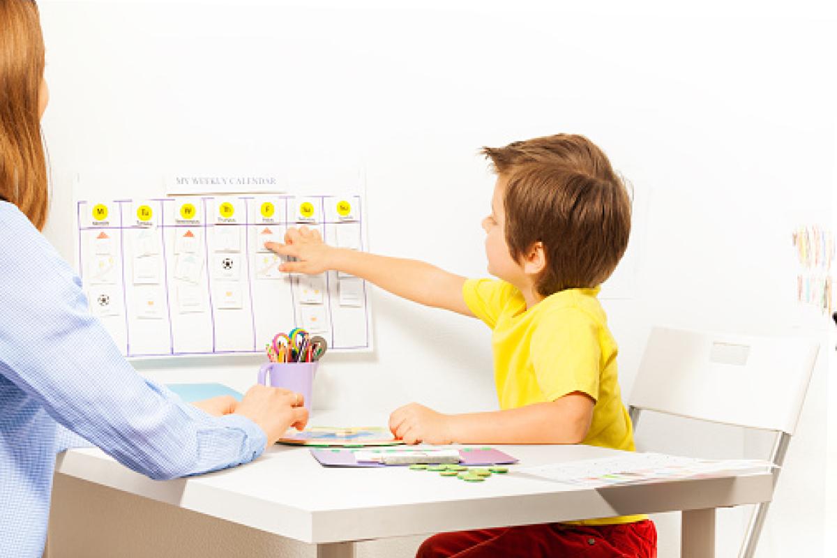 boy pointing at activities on a calendar