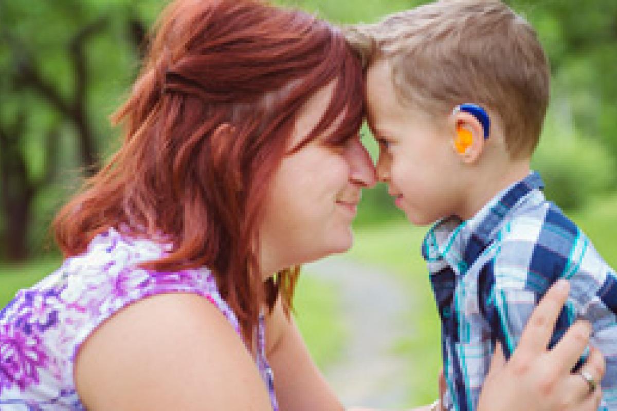 adult and child with hearing aid