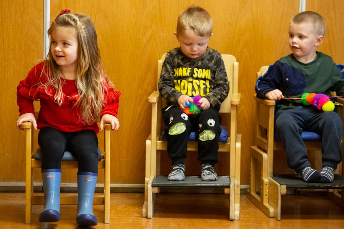 children sitting in chairs