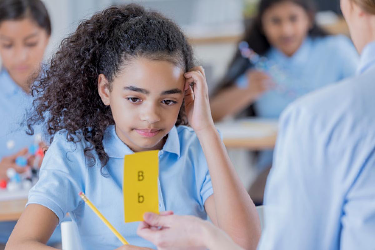 teacher and student using flashcards