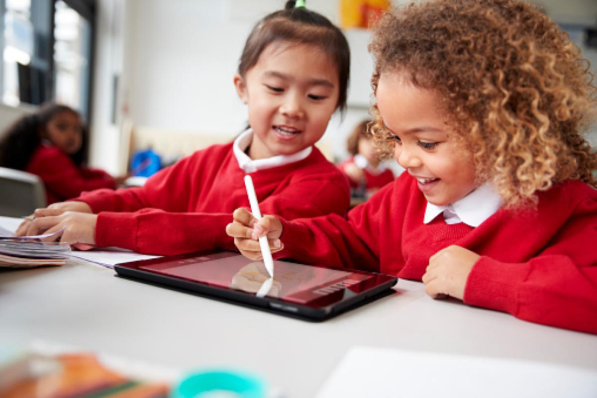 two girls working on a tablet