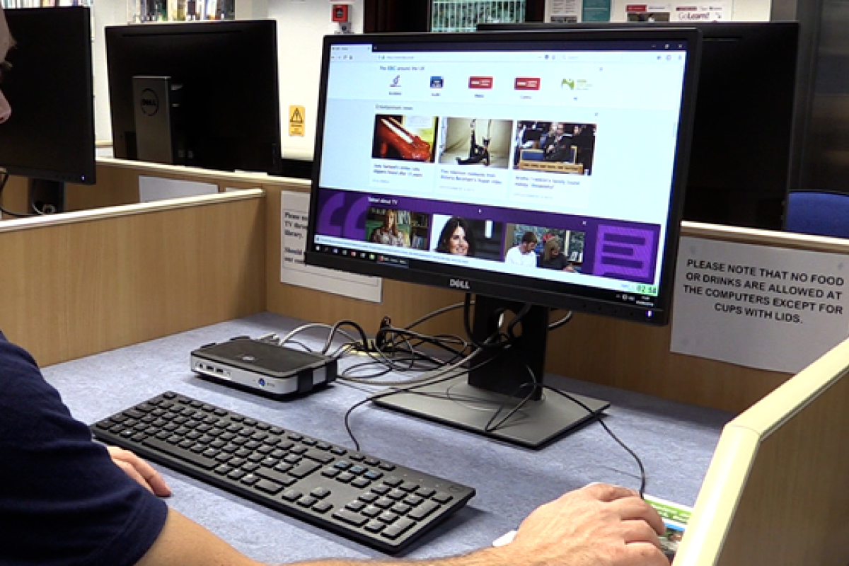 person using a computer in a library