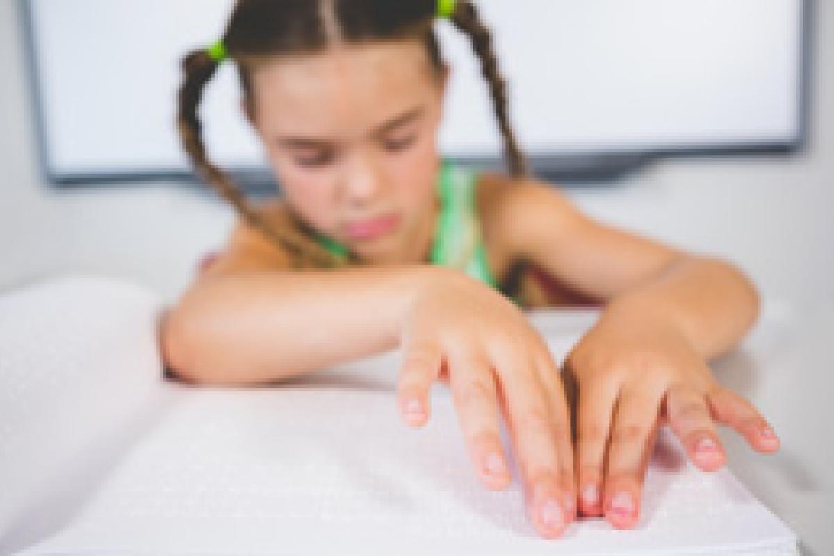 girl reads braille