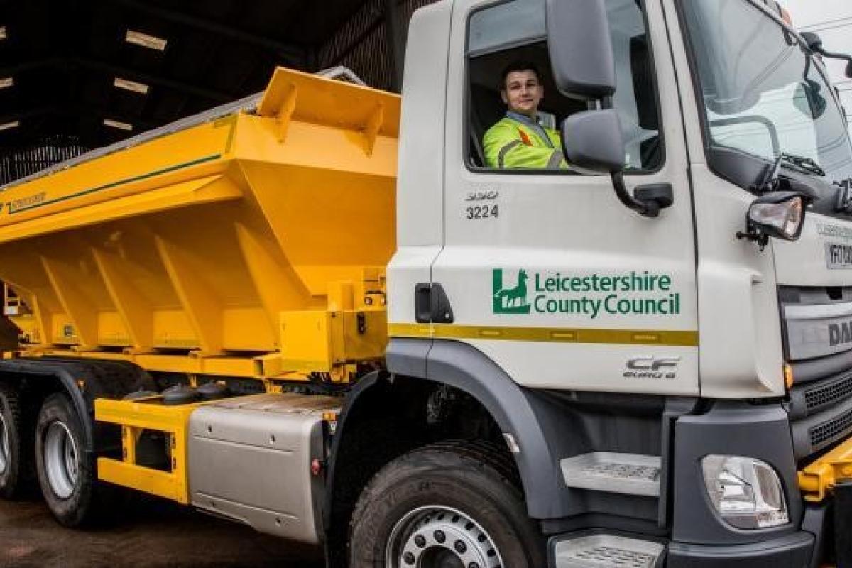 A person driving a gritting lorry
