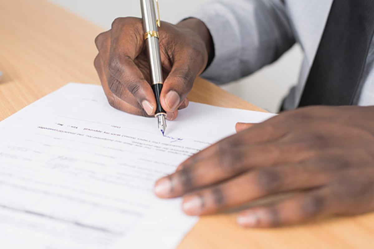 Someone signing an important document