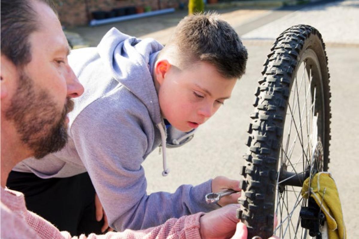 Young person fixing bike