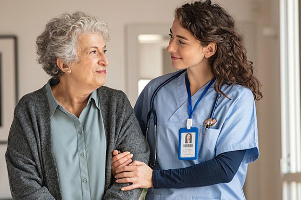 An older person and her carer