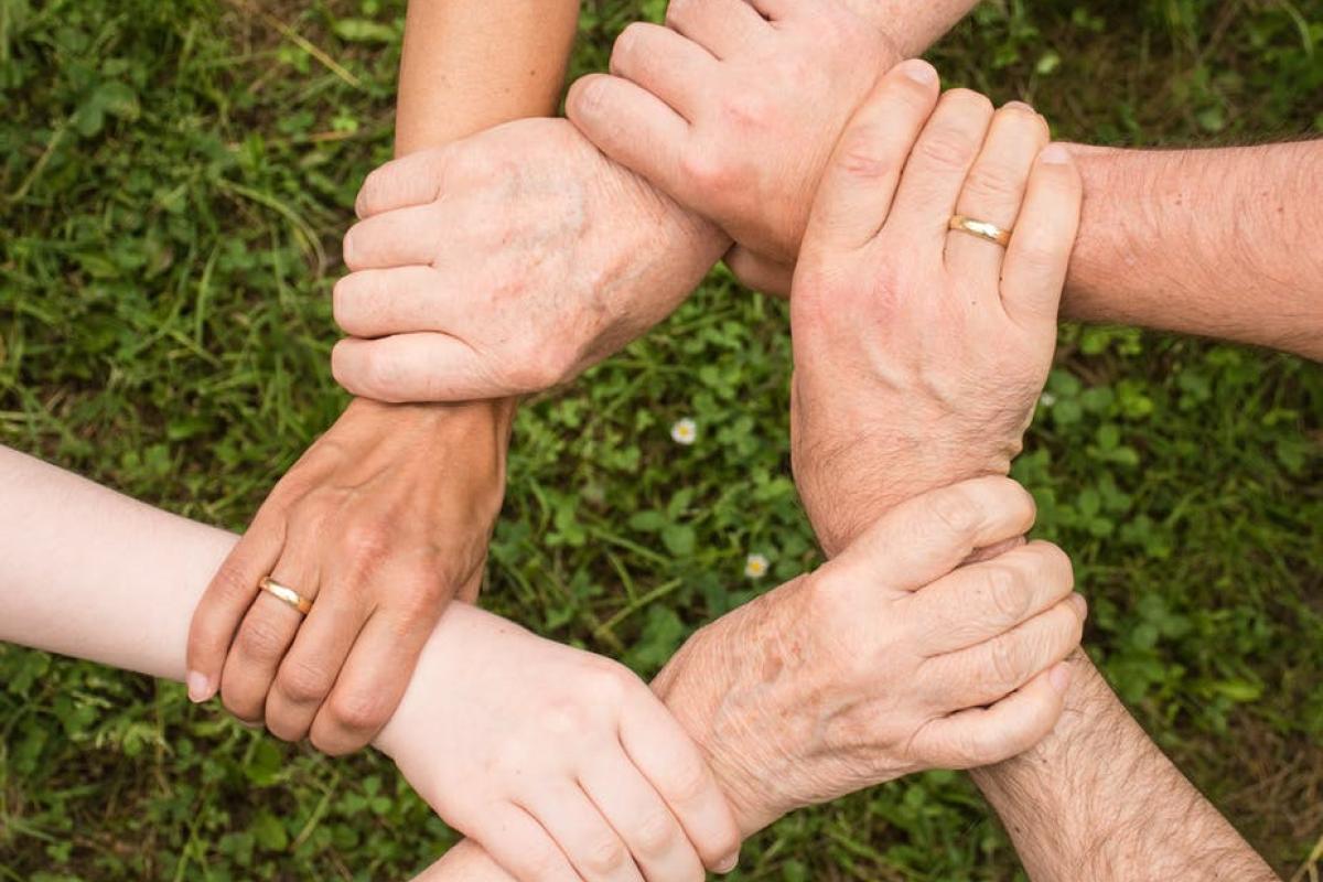 Logo showing hands joined up to mark Carers Week 2019