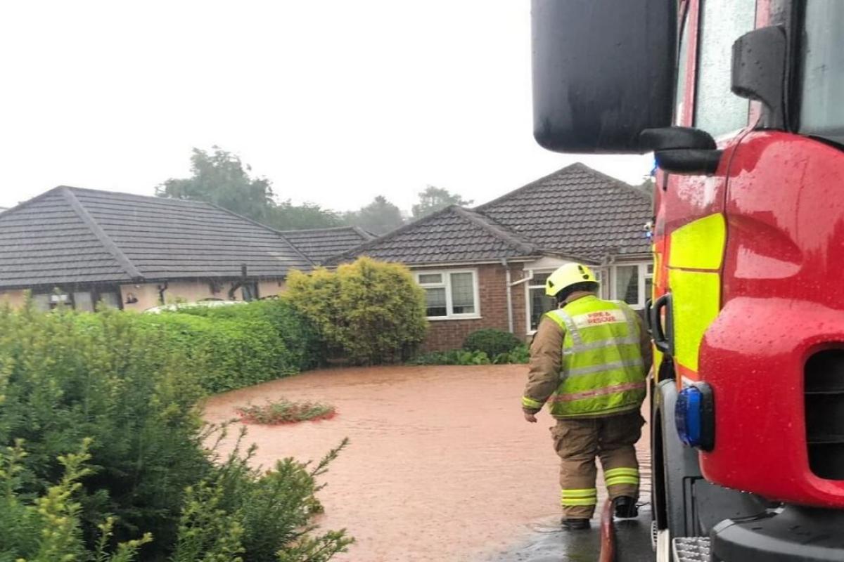 fireman outside flooded home