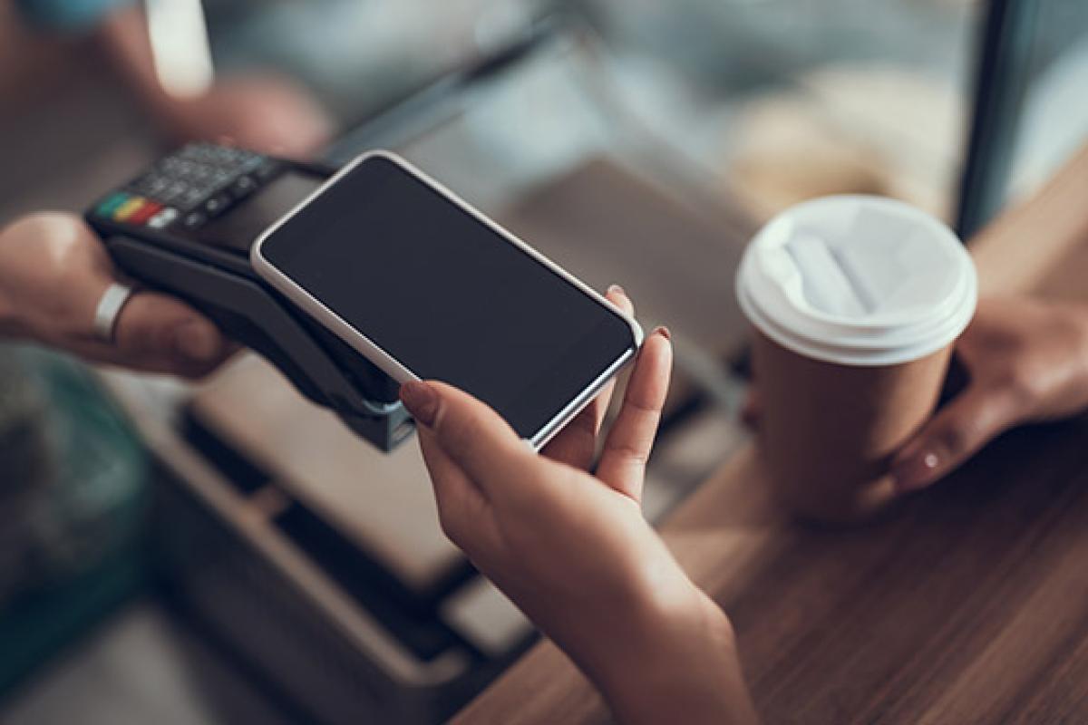 Someone paying contactless using their smartphone